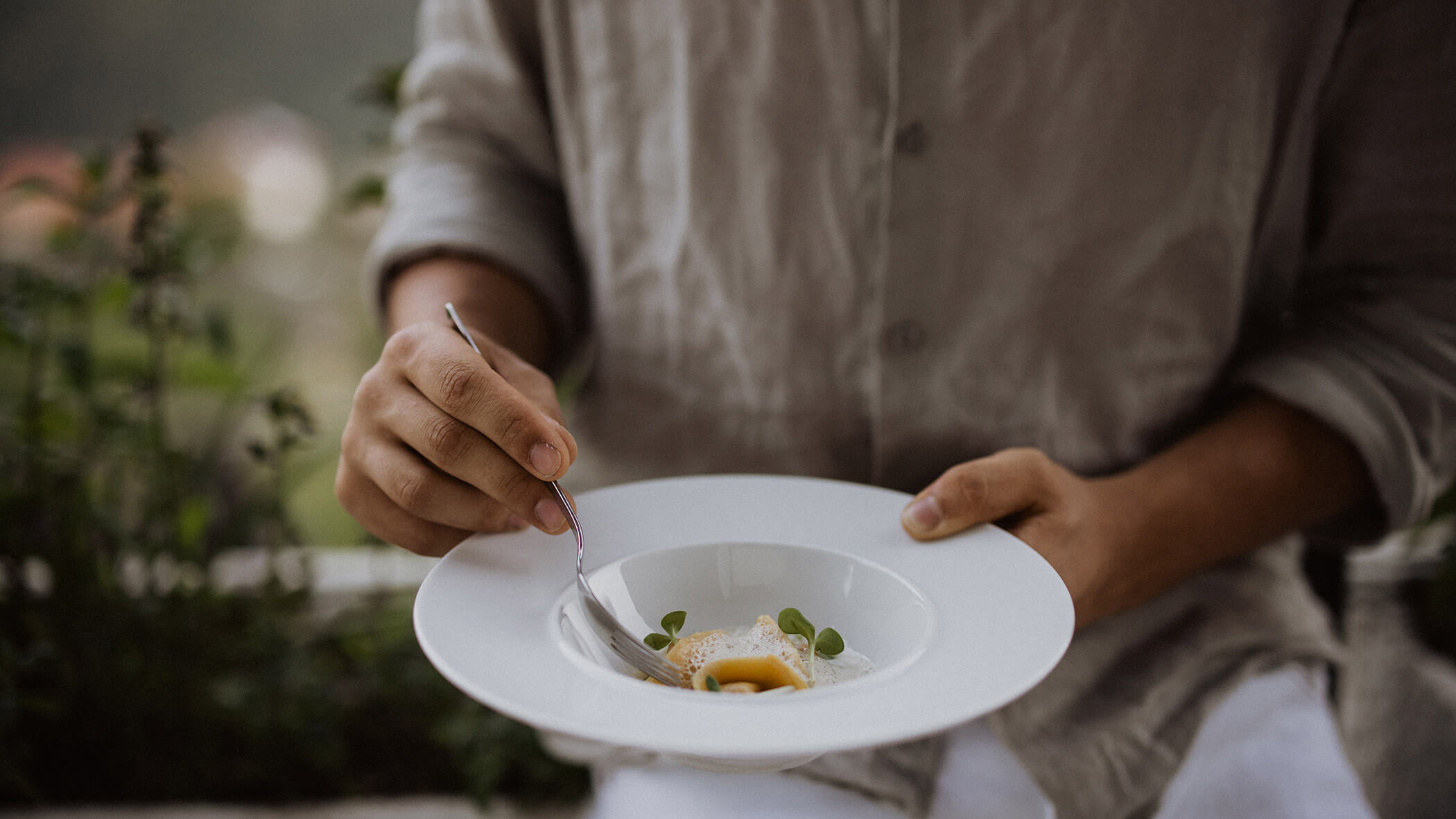 A man holding a plate with a warm starter